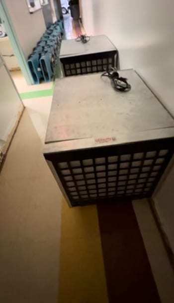 Air scrubber running in a hallway next to air movers