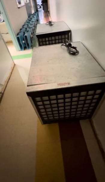 Air scrubber running in a hallway next to air movers