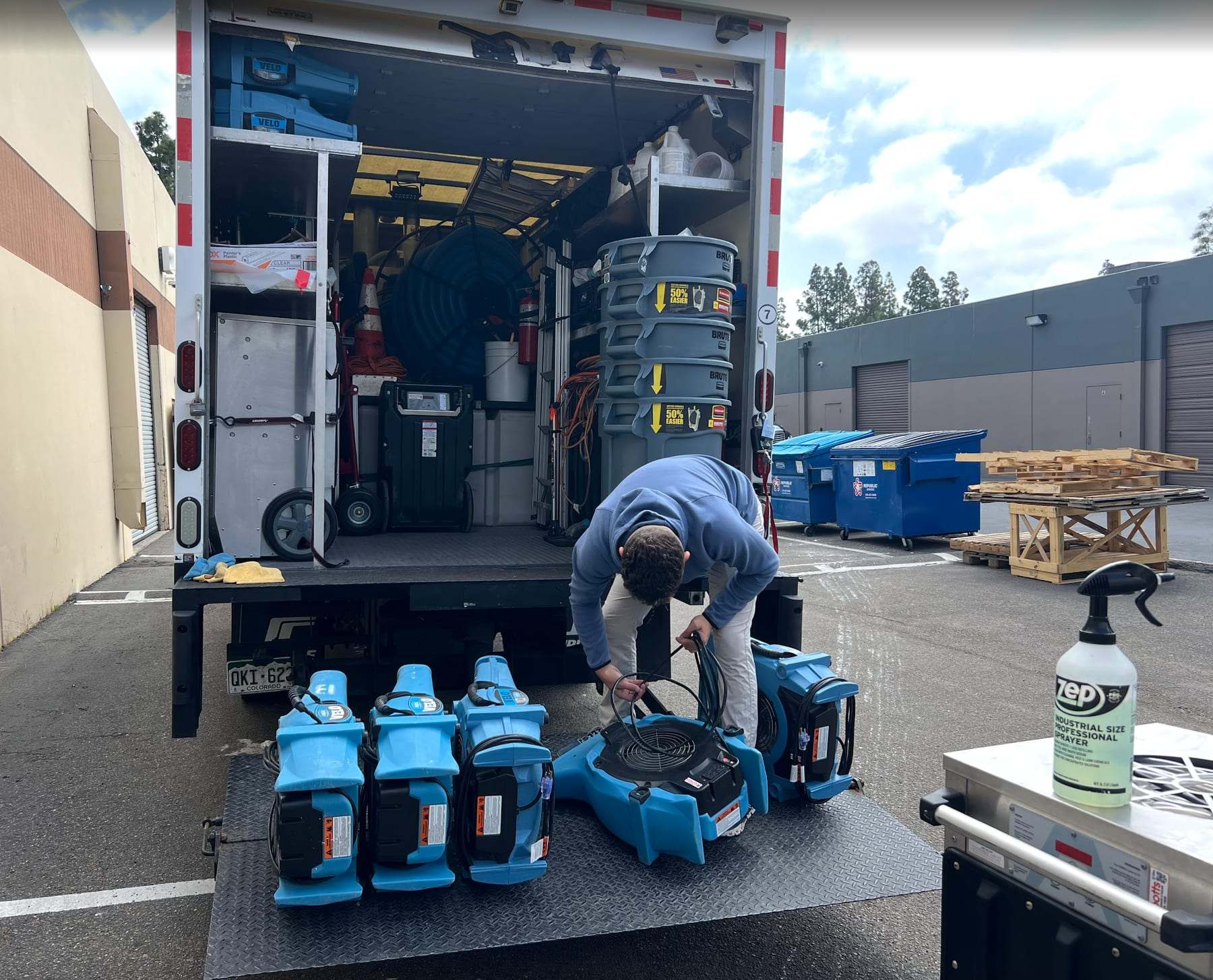 Technician unloading air movers from a box truck