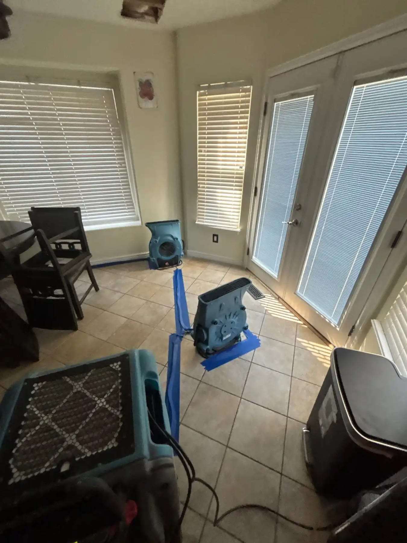 Sunroom with tile flooring, an air mover and a dehumidifier