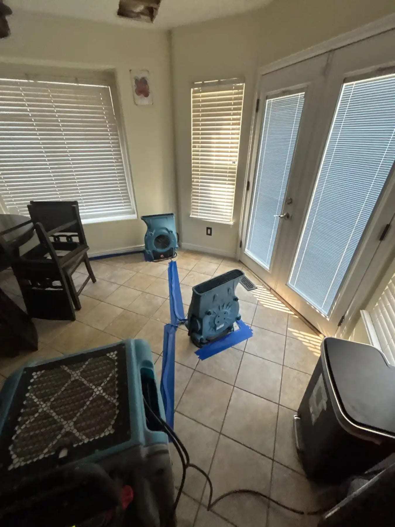 Sunroom with tile flooring, an air mover and a dehumidifier