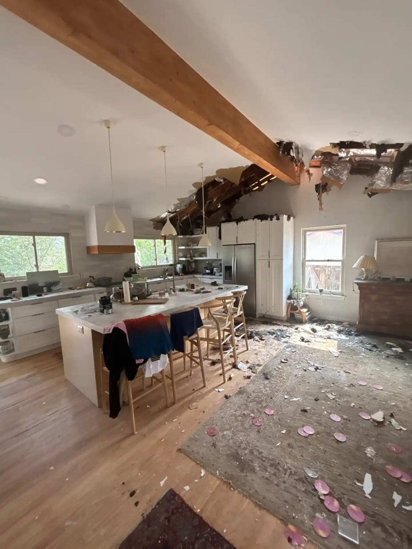 Kitchen with part of the ceiling collapsed and debris on the floor