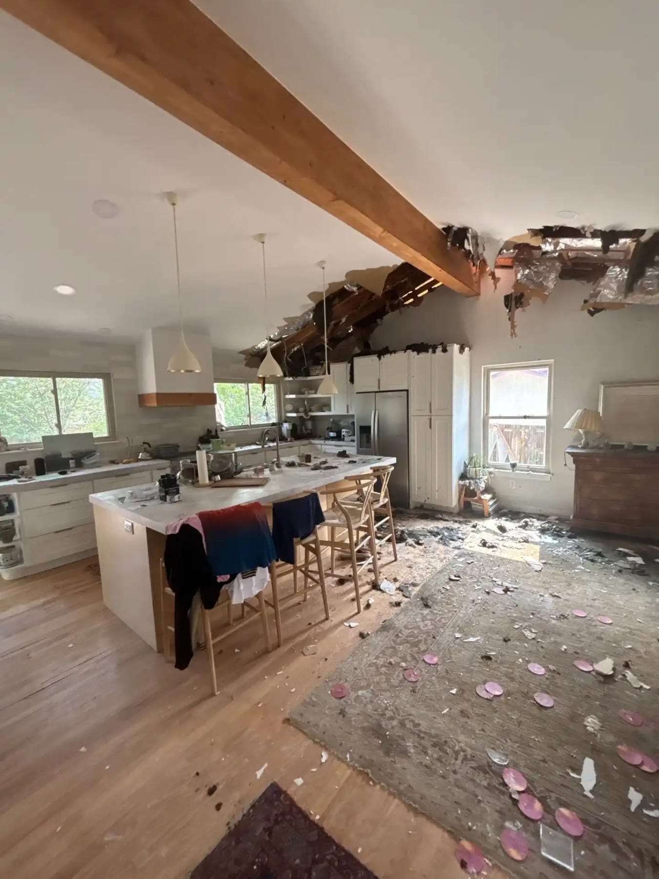 Kitchen with part of the ceiling collapsed and debris on the floor