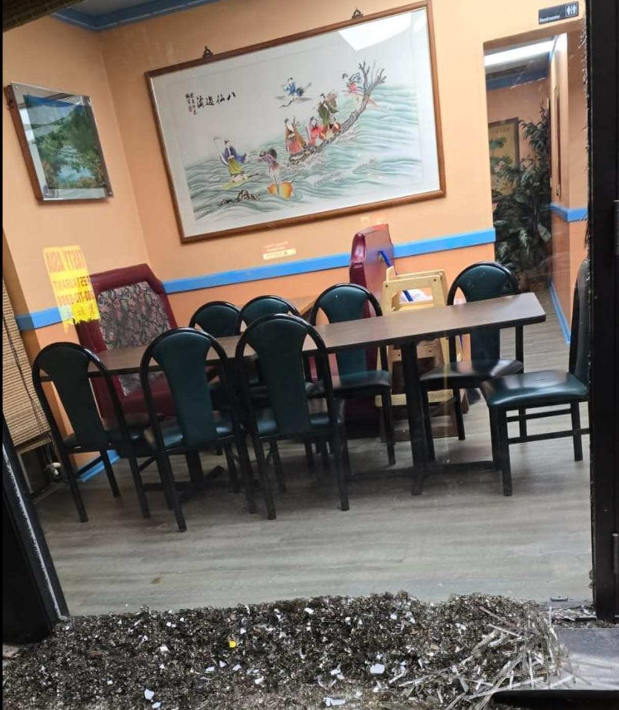 Restaurant dining area with debris on the floor