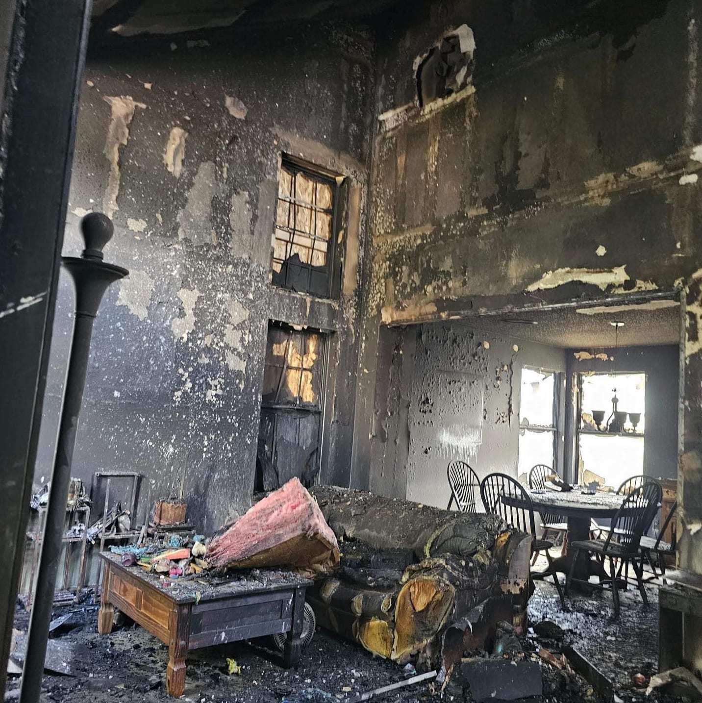 Fire-gutted living room with charred furniture