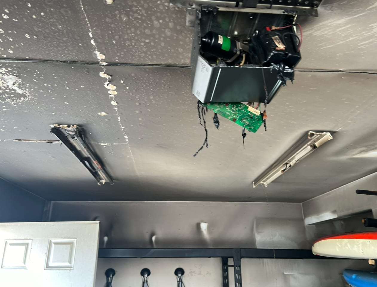 Soot-damaged garage ceiling with a melted light fixture