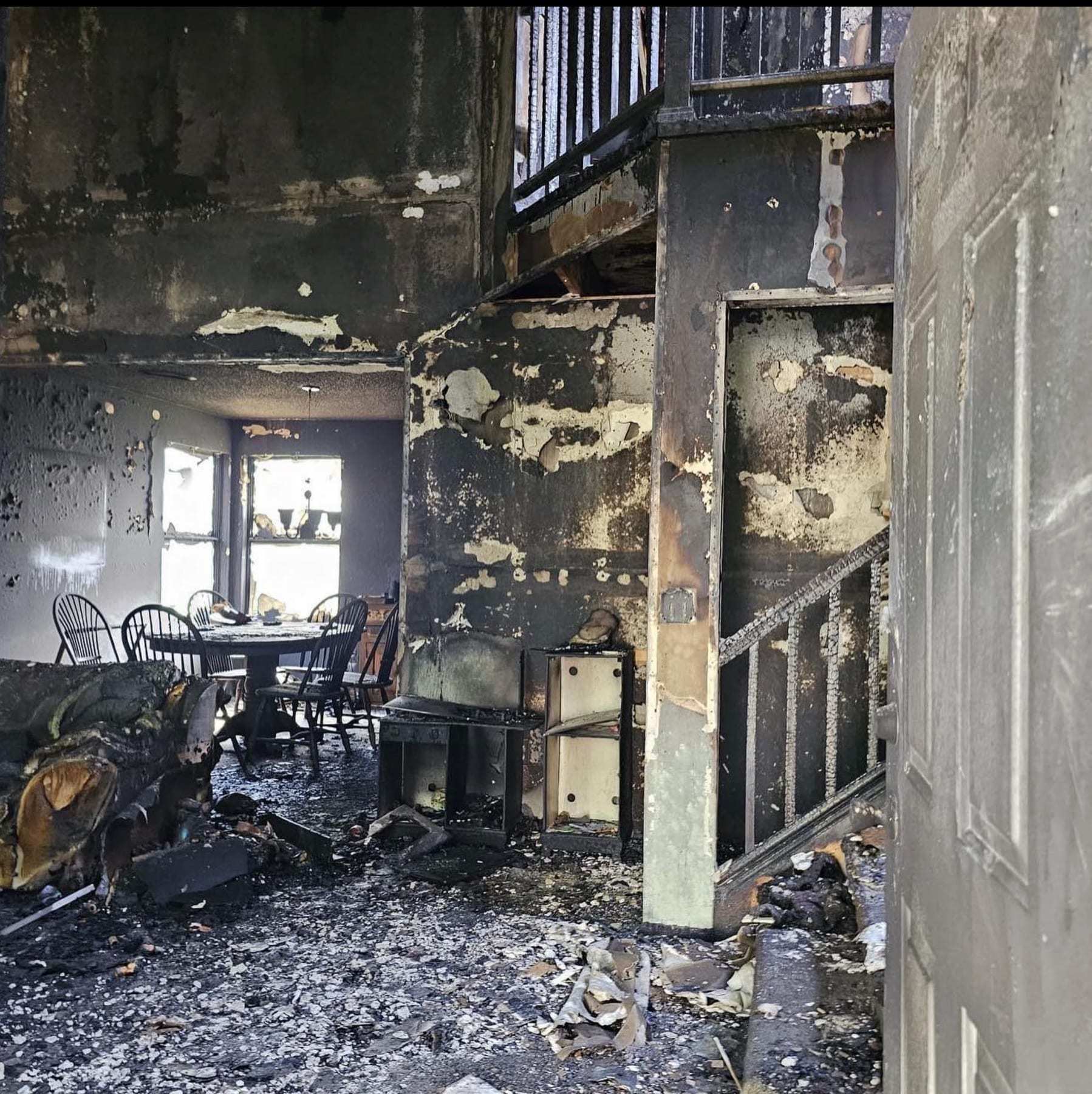 Home interior with charred walls and furniture after a fire