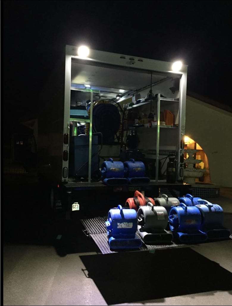 Truck-mounted unit and air movers on a liftgate at night