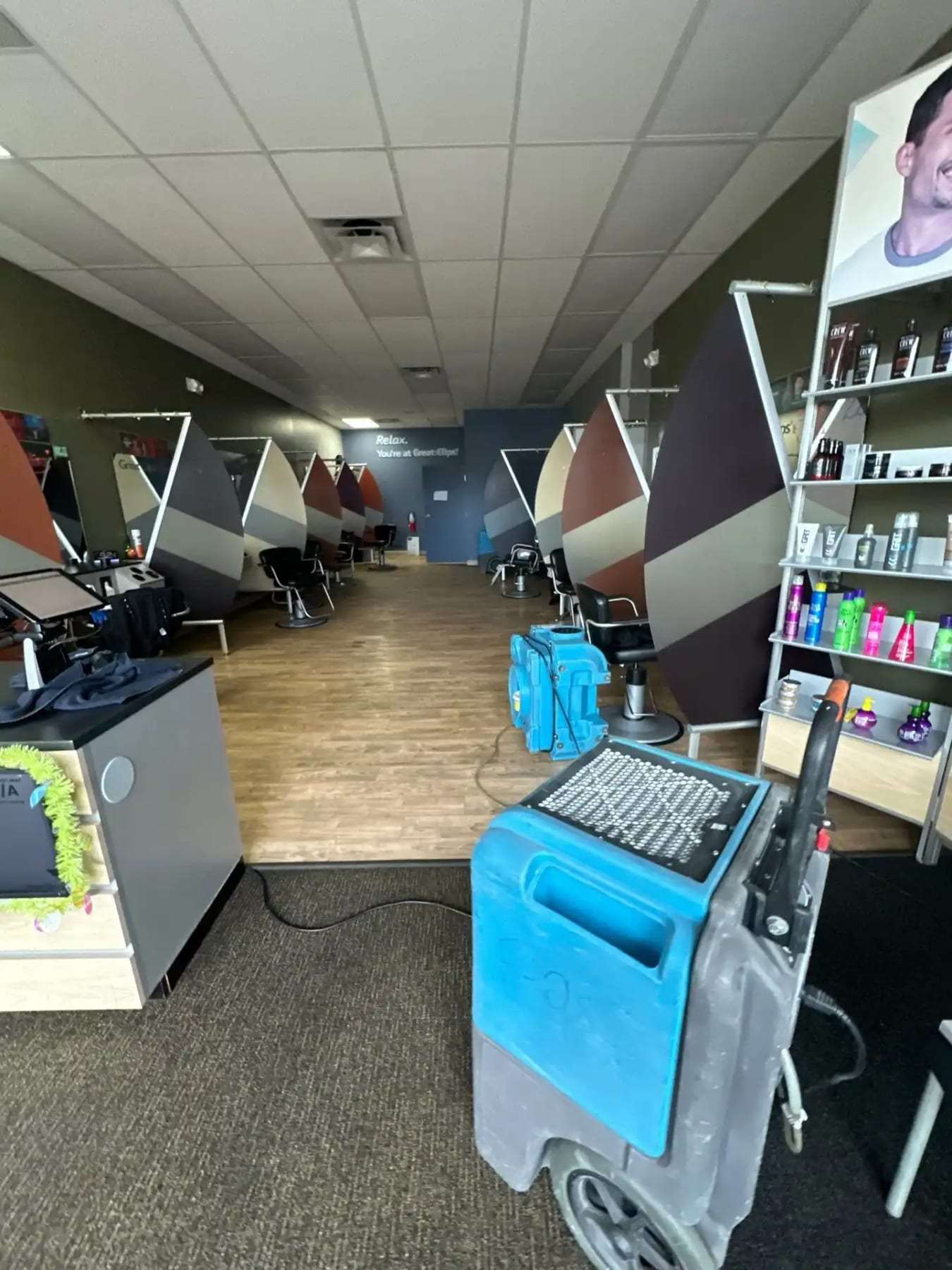 Dehumidifier running in a salon with the chairs pushed aside
