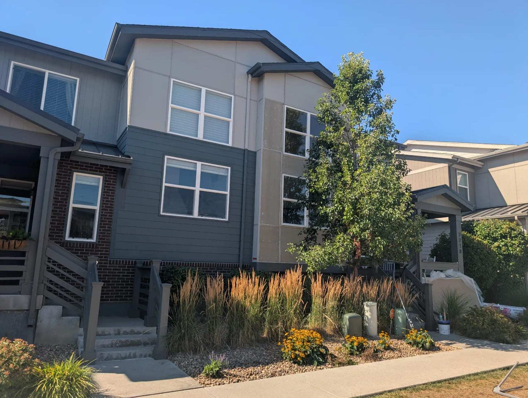 Row of modern townhomes with front gardens