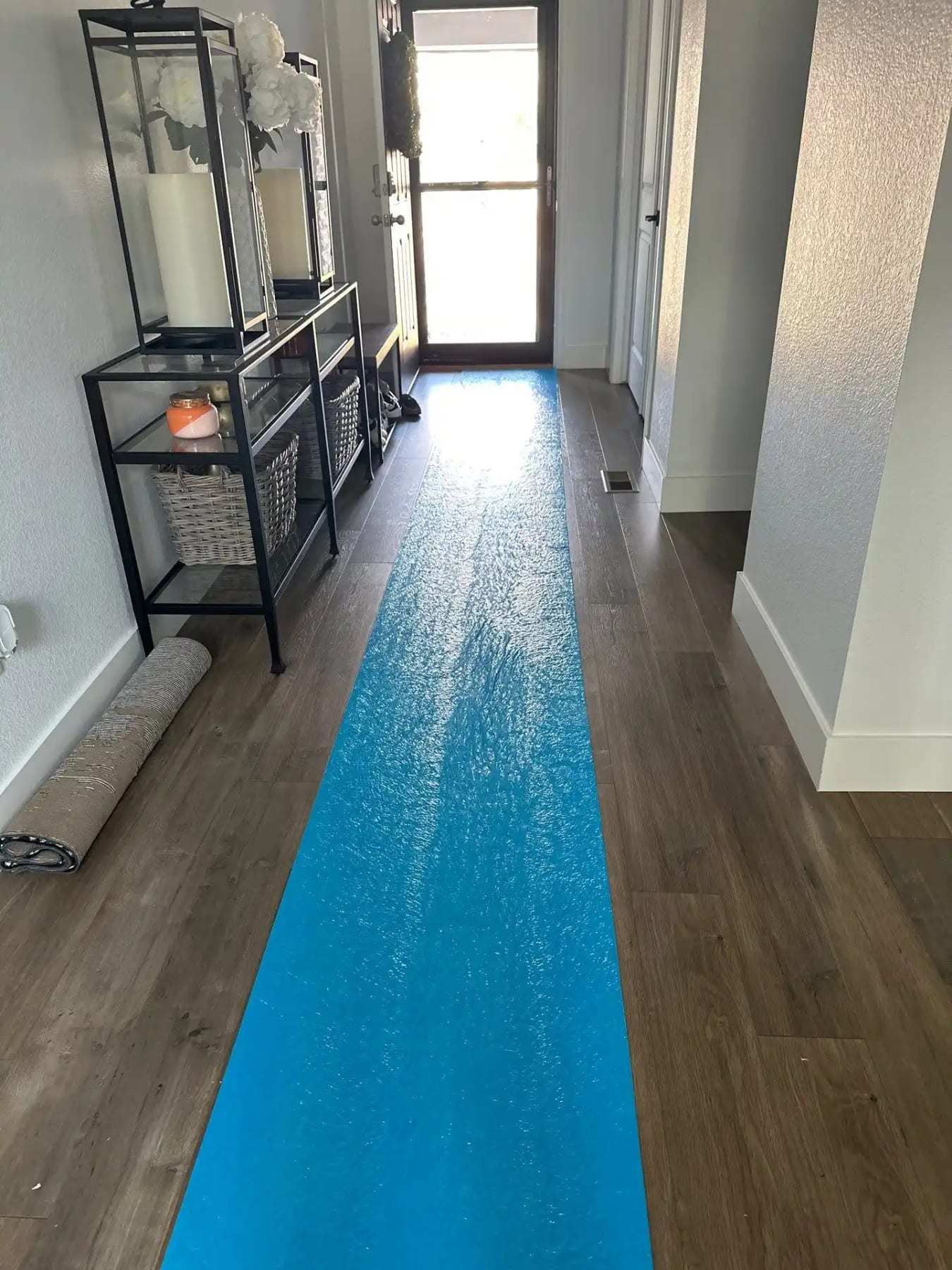 Hallway with a blue protective runner taped over the floor
