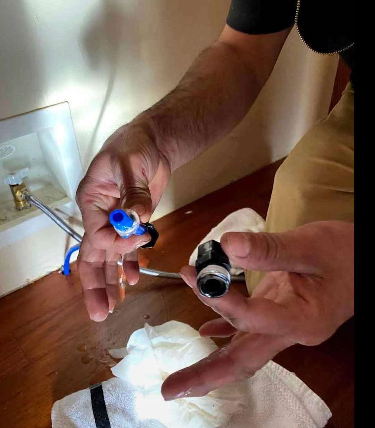 Hands holding a failed water supply line fitting