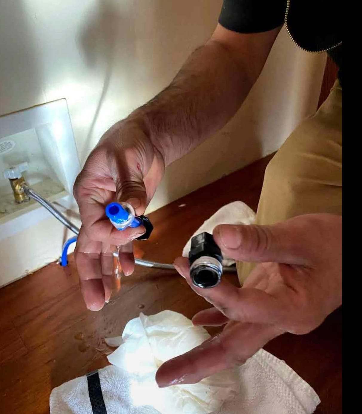 Hands holding a failed water supply line fitting