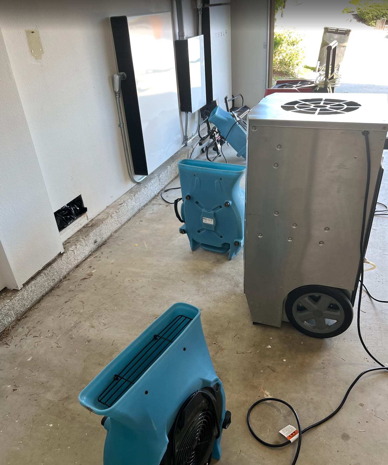 Garage drying setup with air movers and a dehumidifier