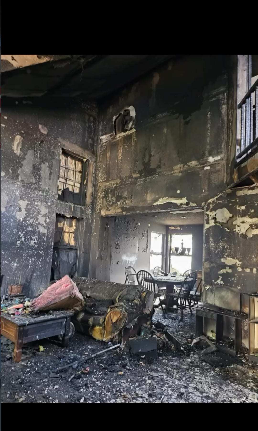 Fire-gutted two-story interior with charred walls