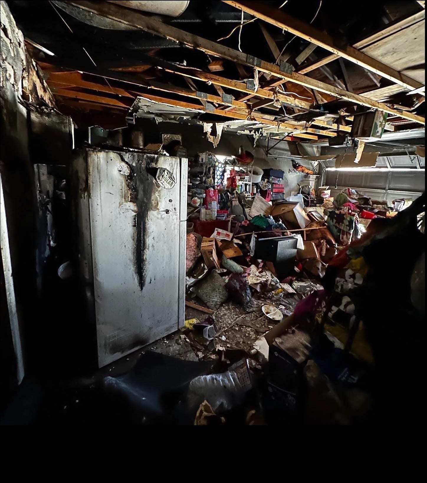 Fire-damaged room with a burned ceiling and debris